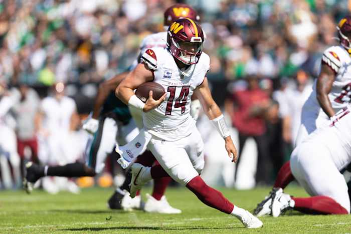 Washington Commanders quarterback Sam Howell (14) runs with the ball during the first quarter against the Philadelphia Eagles at Lincoln Financial Field.
